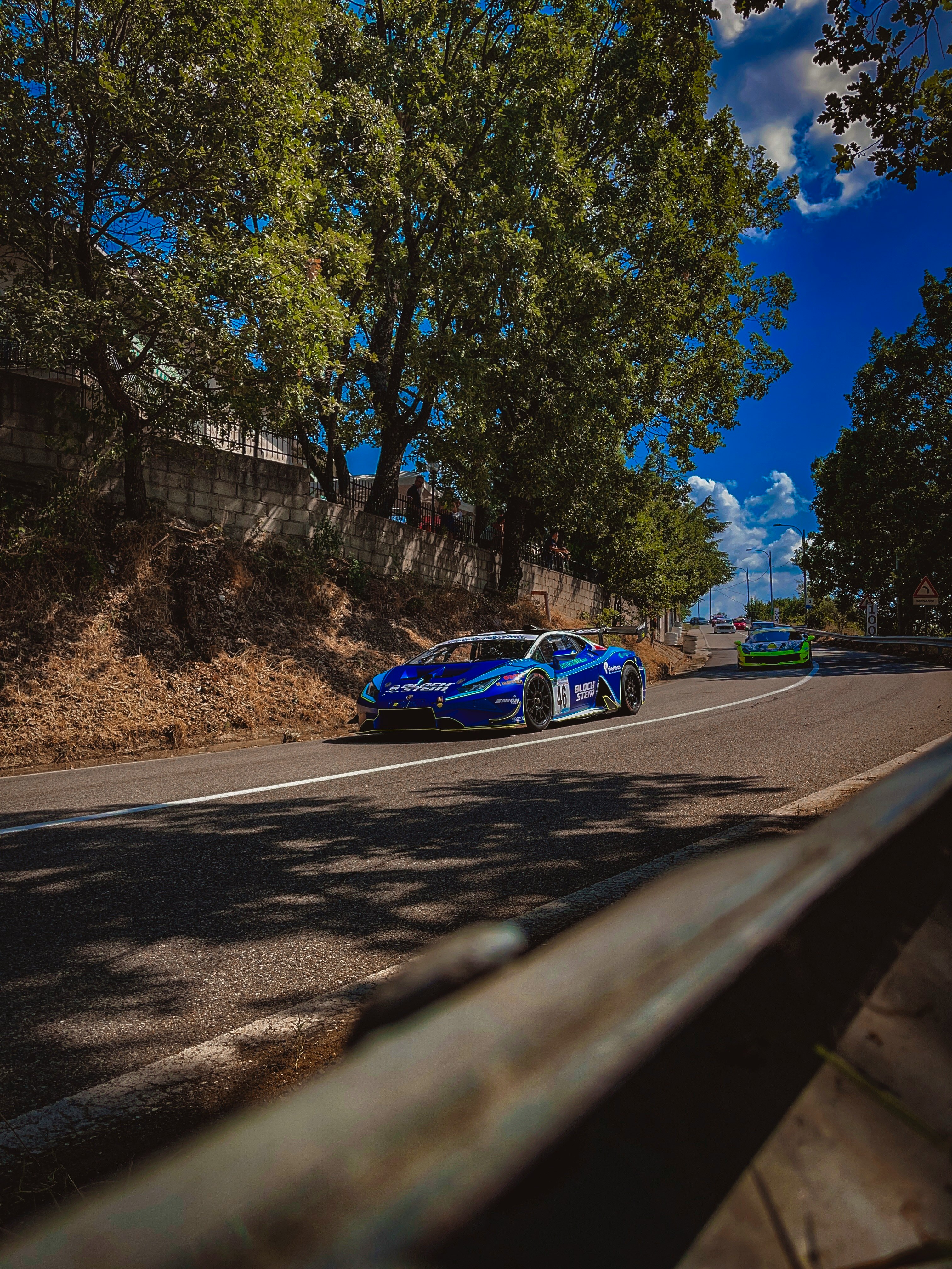 blue and white coupe on road during daytime